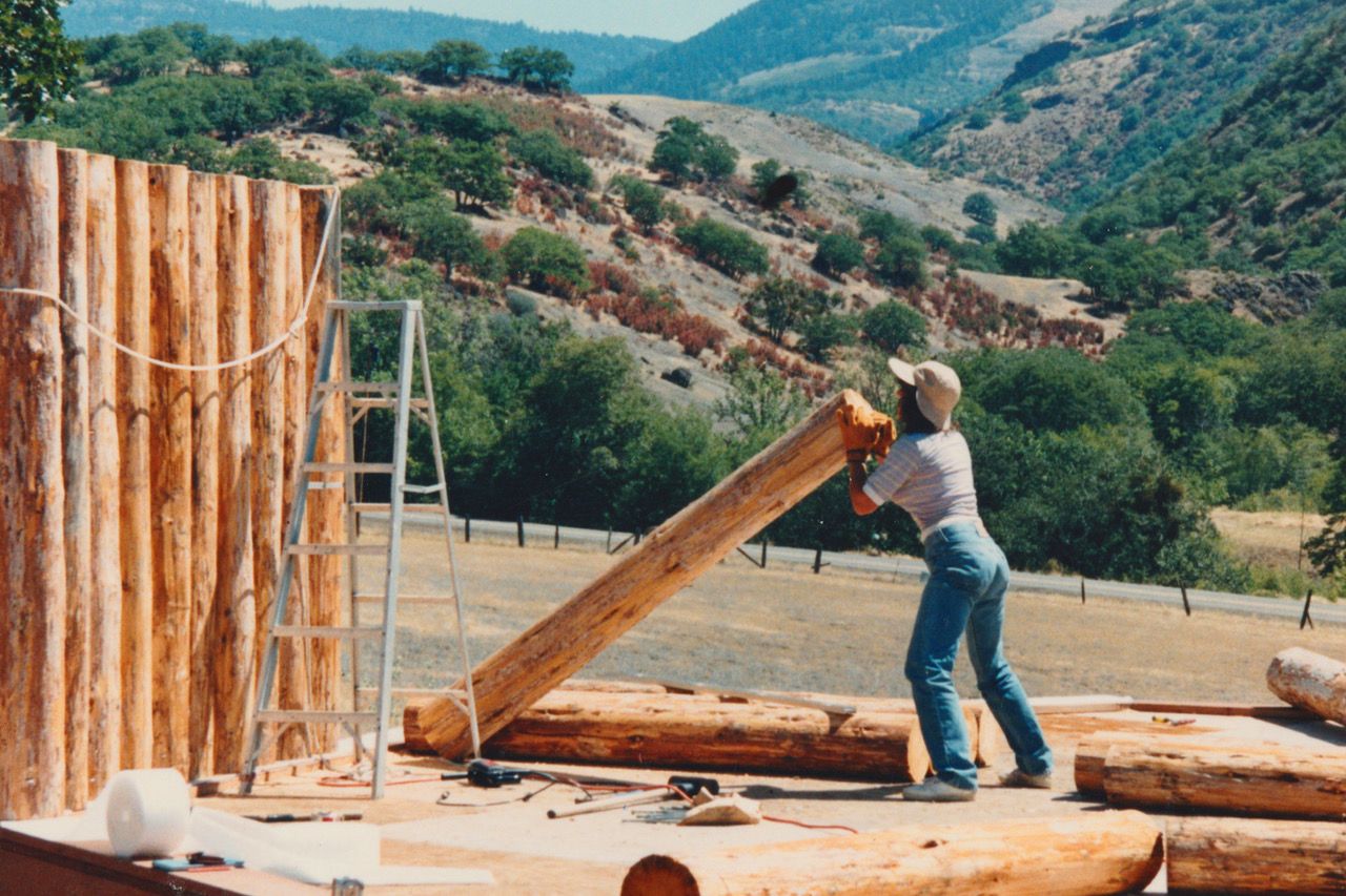 Dorothy lifting lumber during construction.